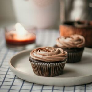 Delicious chocolate cupcakes with swirled frosting on a plate, perfect dessert for teatime.