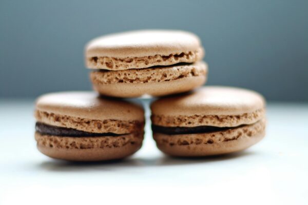 Close-up of stacked chocolate macarons showcasing their texture and filling.